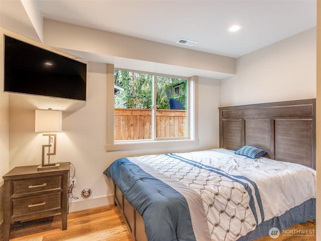 bedroom featuring baseboards, visible vents, wood finished floors, and recessed lighting