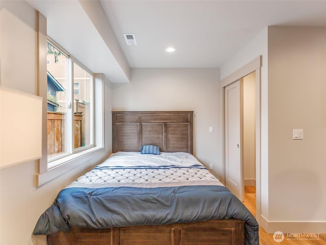 bedroom with baseboards, visible vents, and recessed lighting