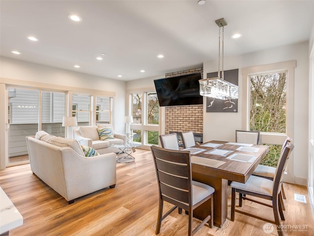 dining space with light wood-style floors and recessed lighting