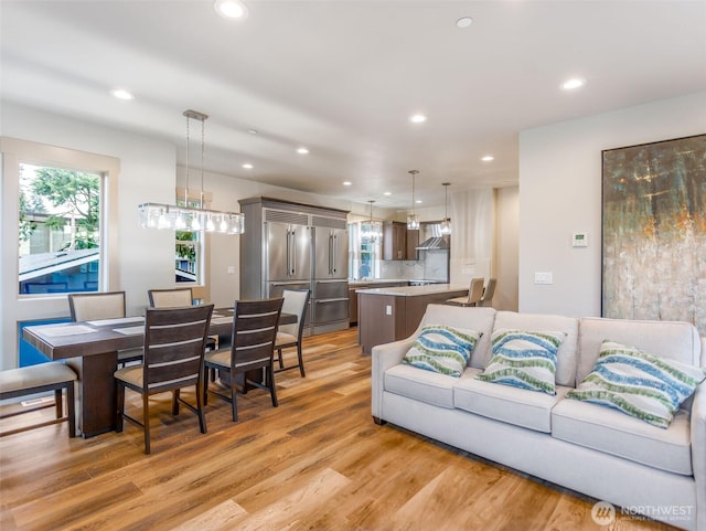 living room featuring light wood-style flooring and recessed lighting