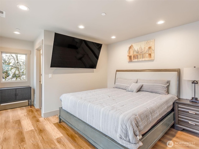 bedroom with recessed lighting, baseboards, and wood finished floors