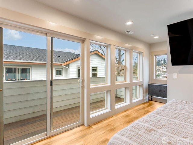 interior space with light wood-style floors, visible vents, and recessed lighting