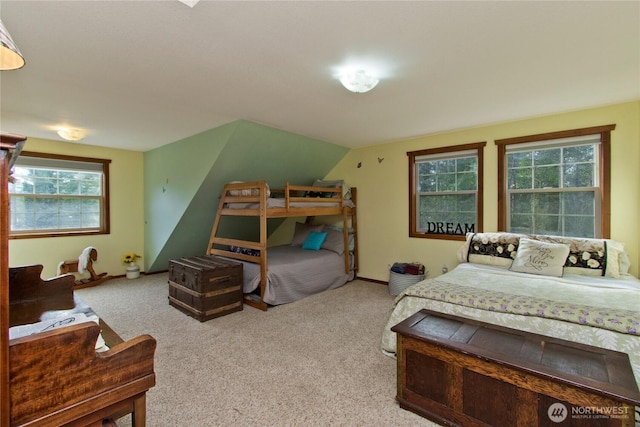 bedroom featuring vaulted ceiling, carpet floors, and baseboards