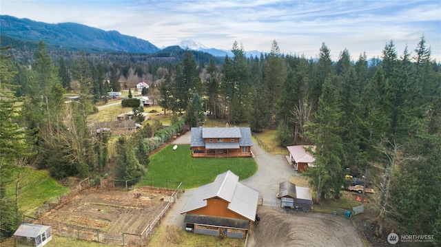 drone / aerial view featuring a forest view and a mountain view