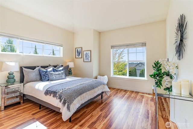 bedroom featuring baseboards and wood finished floors