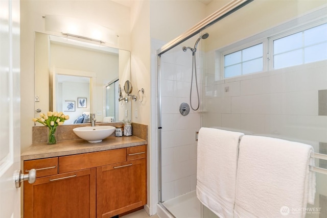 bathroom featuring a shower stall and vanity