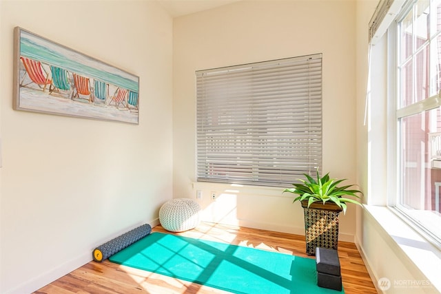 living area with wood finished floors and baseboards