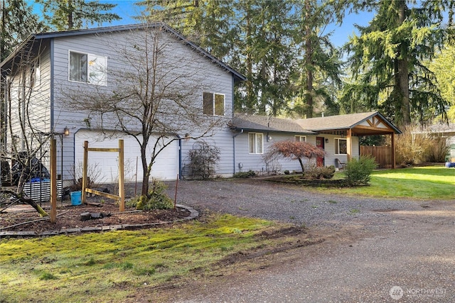 view of front of house with a garage, driveway, and a front lawn