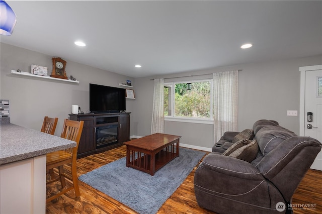 living room with recessed lighting, baseboards, and wood finished floors