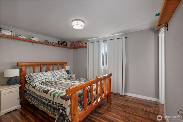 bedroom with dark wood-style flooring and baseboards