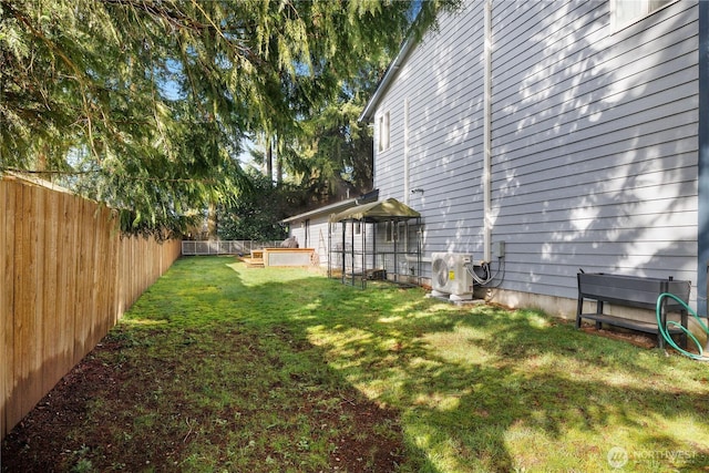 view of yard with ac unit and a fenced backyard