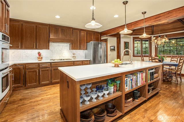 kitchen with open shelves, light countertops, appliances with stainless steel finishes, light wood-style floors, and beamed ceiling