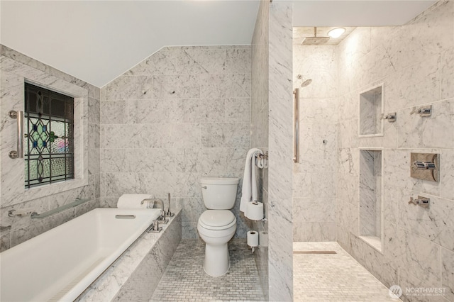 bathroom with a garden tub, tile walls, lofted ceiling, toilet, and a tile shower