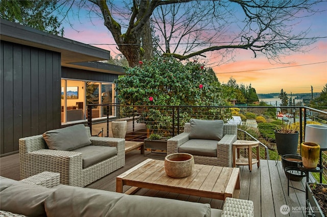 deck at dusk featuring outdoor lounge area