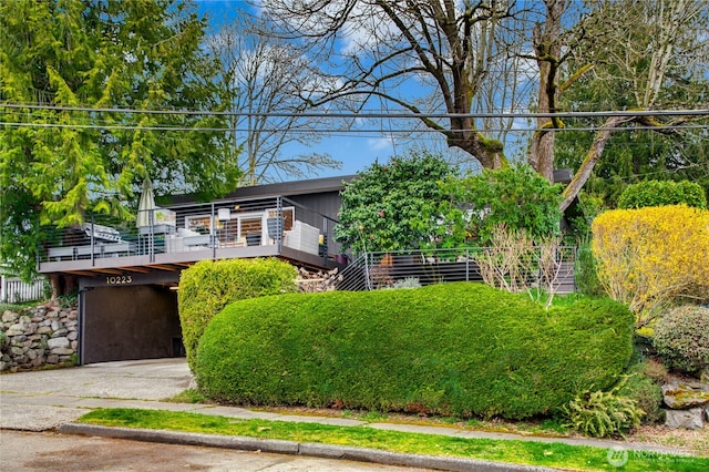 view of front facade featuring stairway and driveway