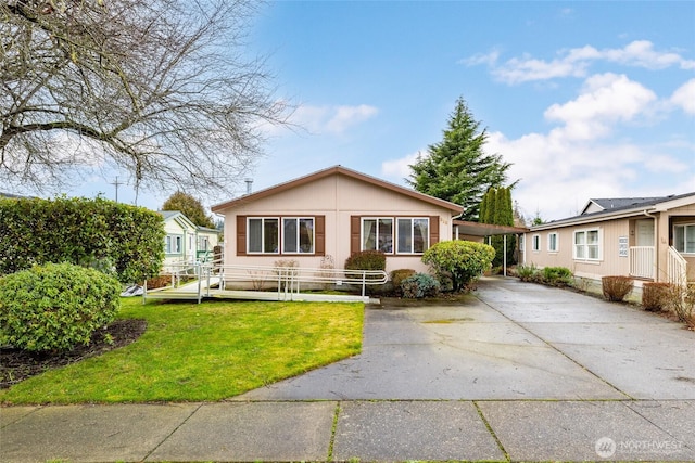 view of front facade featuring concrete driveway and a front yard