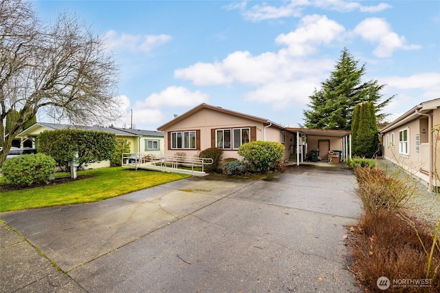 view of front of house with a front yard and concrete driveway