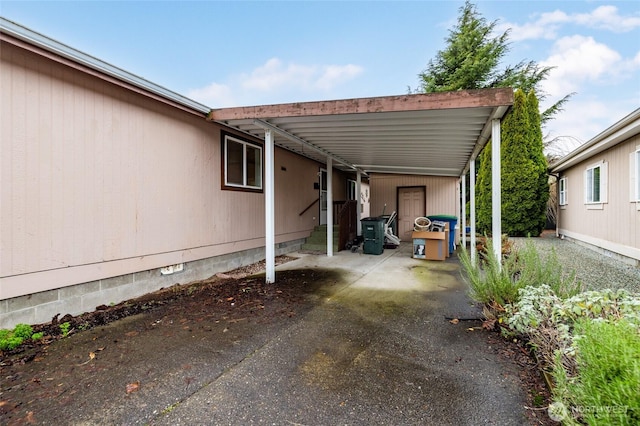 view of car parking with an attached carport and driveway