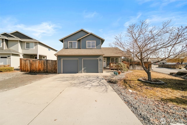 traditional home featuring driveway, an attached garage, and fence