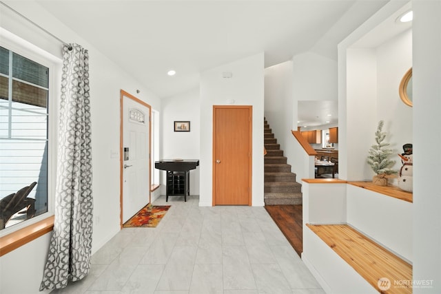 entryway with stairway, vaulted ceiling, and recessed lighting