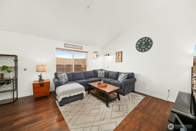 living area with high vaulted ceiling, wood finished floors, and baseboards