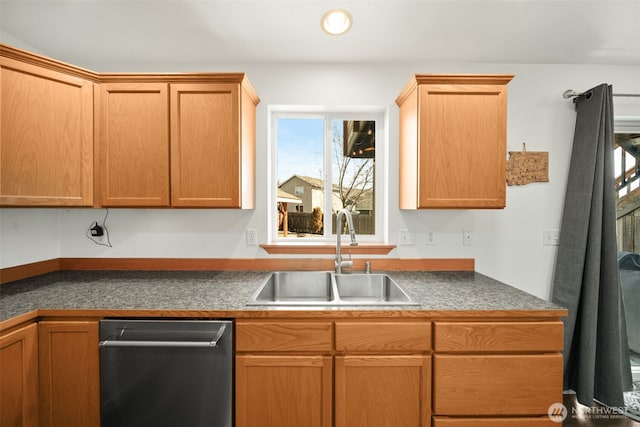 kitchen with dishwashing machine, dark countertops, a sink, and recessed lighting