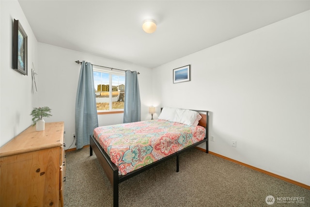 carpeted bedroom featuring baseboards