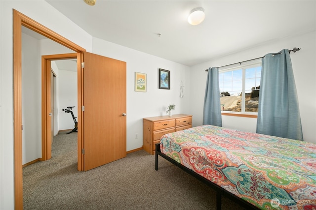 bedroom with carpet flooring and baseboards