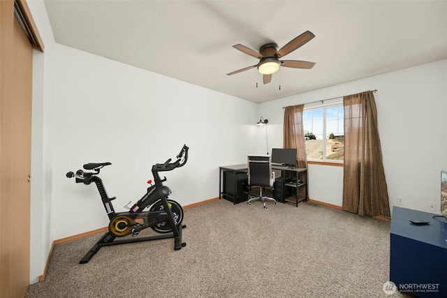 carpeted home office featuring baseboards and a ceiling fan