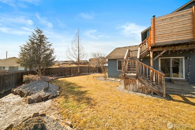 view of yard with stairs and a fenced backyard