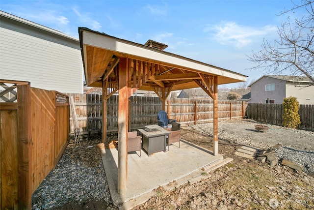 view of patio with a gazebo, an outdoor fire pit, and a fenced backyard