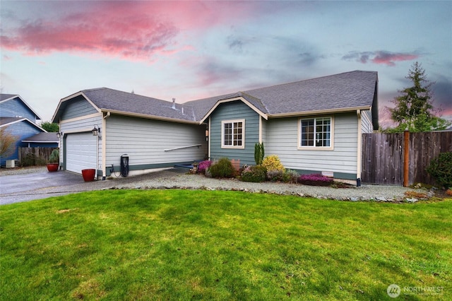 ranch-style home featuring roof with shingles, a yard, fence, a garage, and driveway