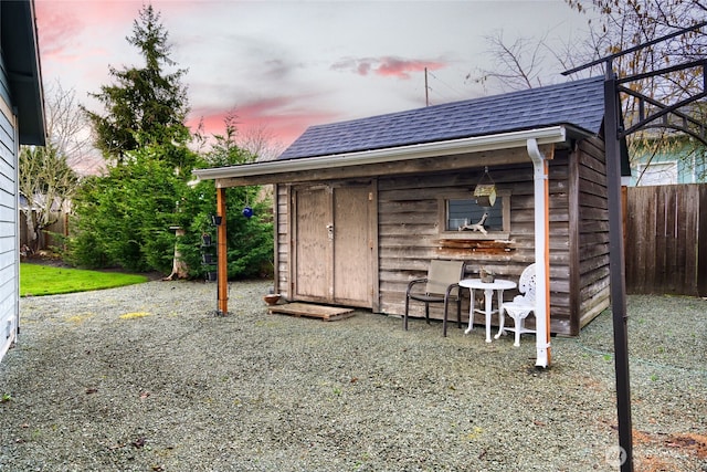 view of outdoor structure featuring an outbuilding and fence