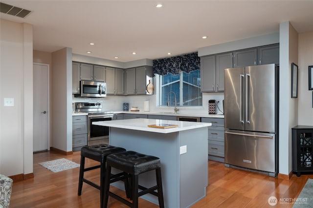 kitchen featuring visible vents, wine cooler, appliances with stainless steel finishes, and gray cabinets