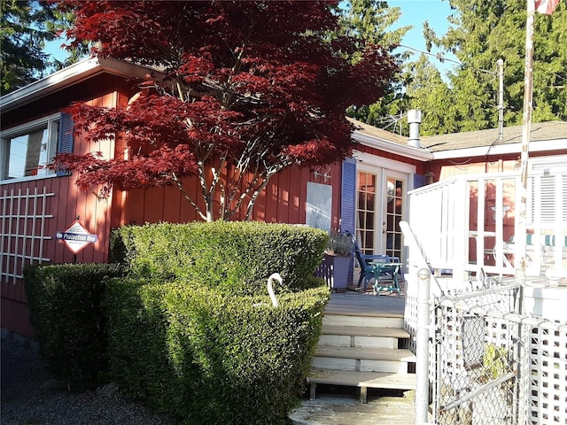 exterior space with a deck and french doors