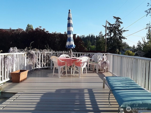 wooden deck with outdoor dining space