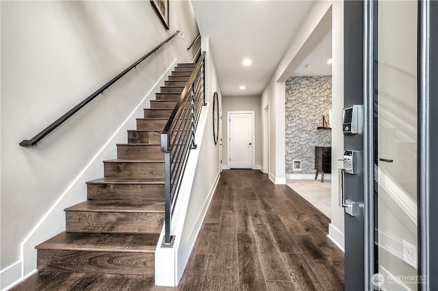 interior space with baseboards, wood finished floors, and recessed lighting