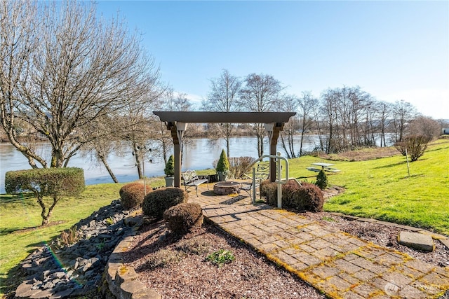 view of yard with a fire pit and a water view