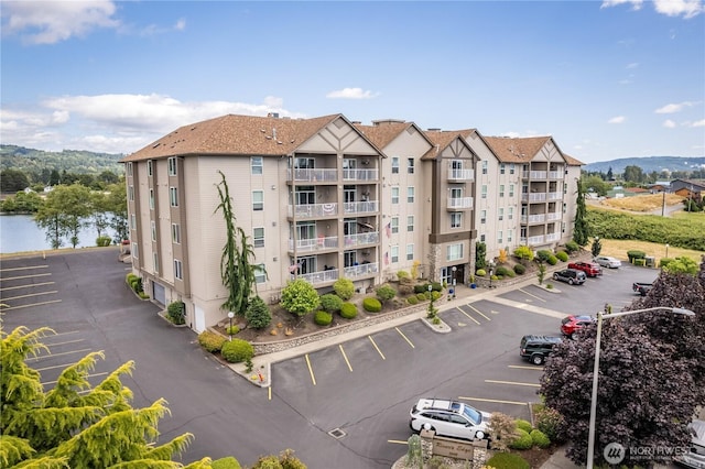 view of property with uncovered parking