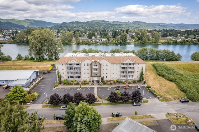 drone / aerial view featuring a water and mountain view