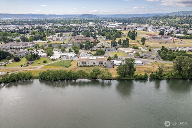 drone / aerial view with a water and mountain view