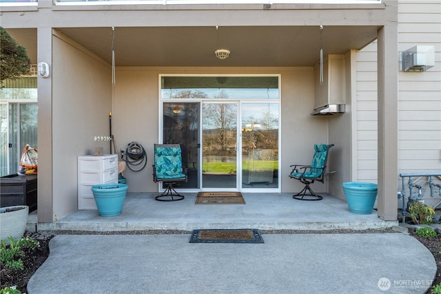 entrance to property with a patio area and stucco siding