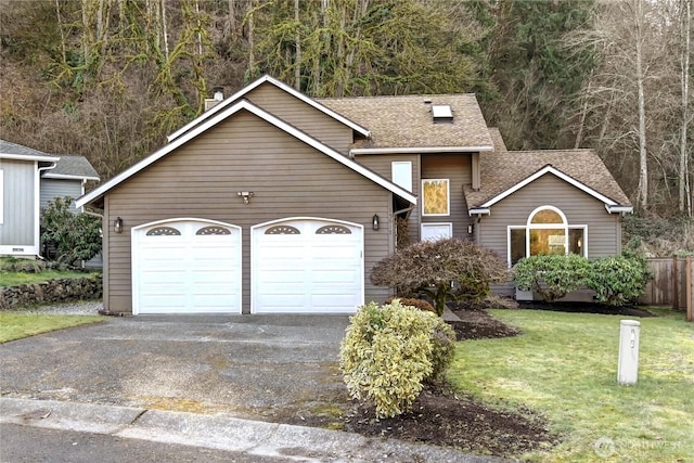 view of front of home with a garage, aphalt driveway, a front yard, and a shingled roof