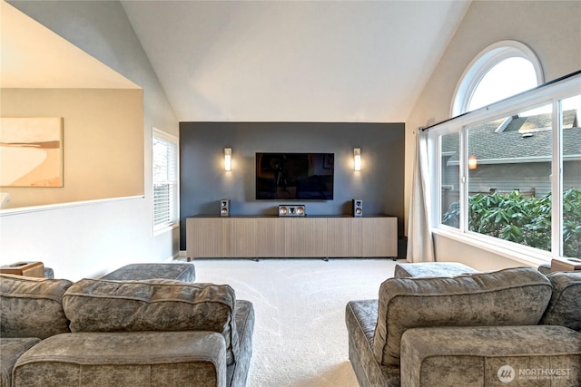 carpeted living area with vaulted ceiling