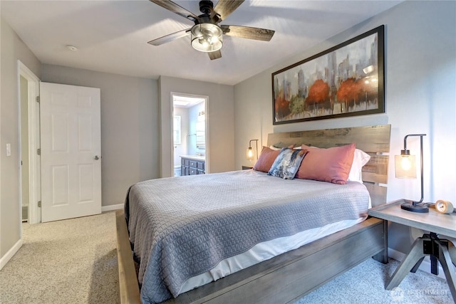 bedroom with ceiling fan, carpet floors, ensuite bathroom, and baseboards