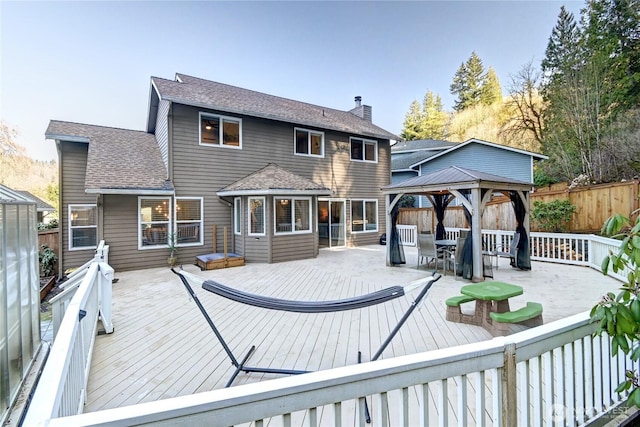 exterior space featuring a fenced backyard and a gazebo