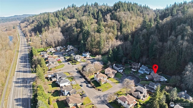 birds eye view of property with a residential view and a forest view