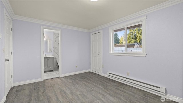 unfurnished bedroom featuring a baseboard heating unit, crown molding, wood finished floors, and baseboards