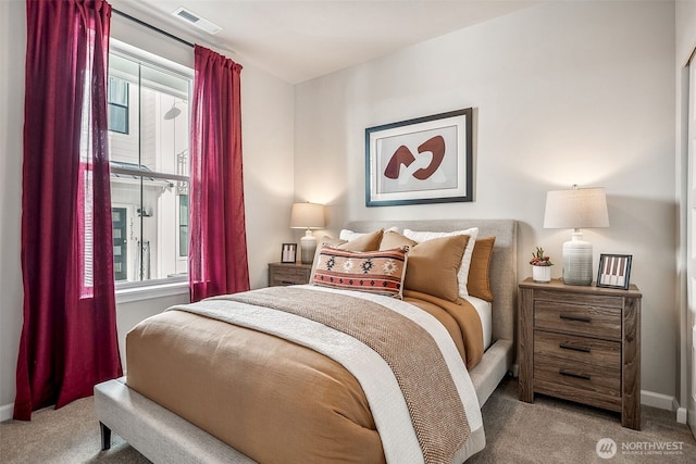 bedroom with carpet, visible vents, and baseboards