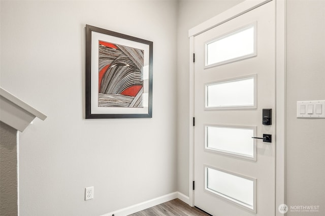 entryway with baseboards and wood finished floors